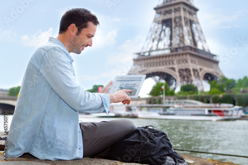 Fotografie Young attractive tourist using tablet in Paris
