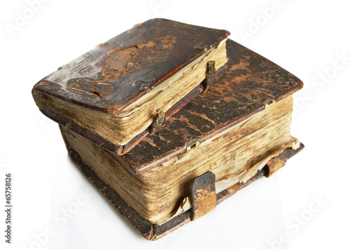Ancient worn books with leather cover on light background