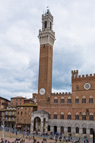 Clock tower of a city hall on main square in Siena