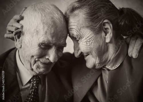 Cute 80 plus year old married couple posing for a portrait