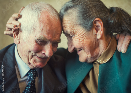 Cute 80 plus year old married couple posing for a portrait