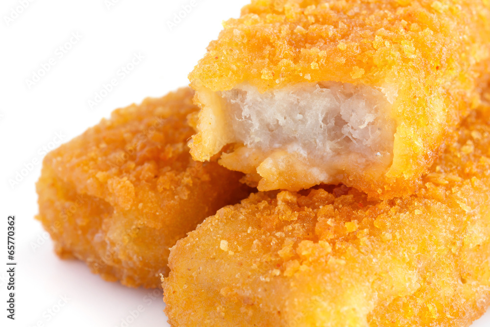 Fried fishfingers on white surface Fried fishfingers on white surface