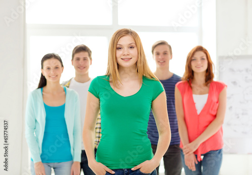 smiling students with teenage girl in front