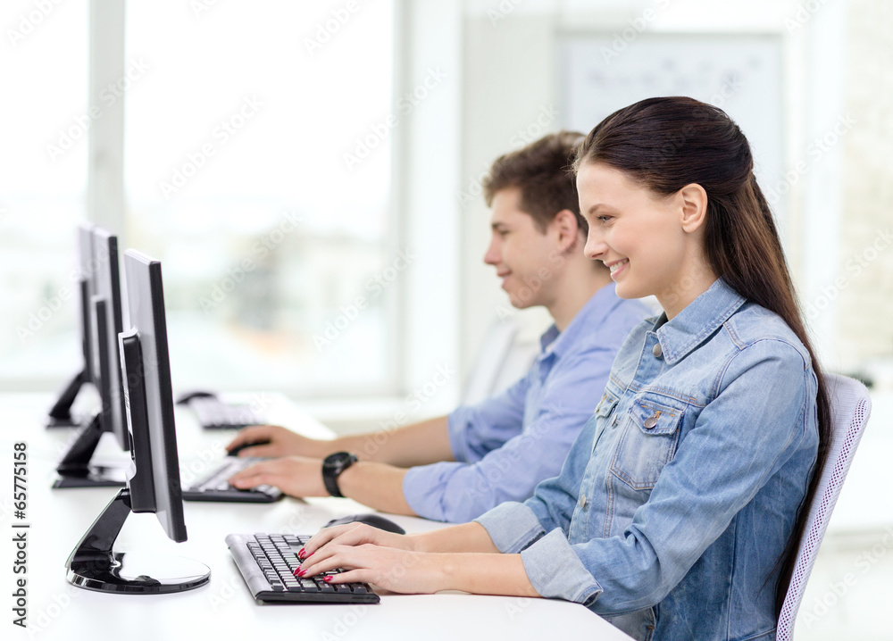 two smiling students in computer class two smiling students in computer class