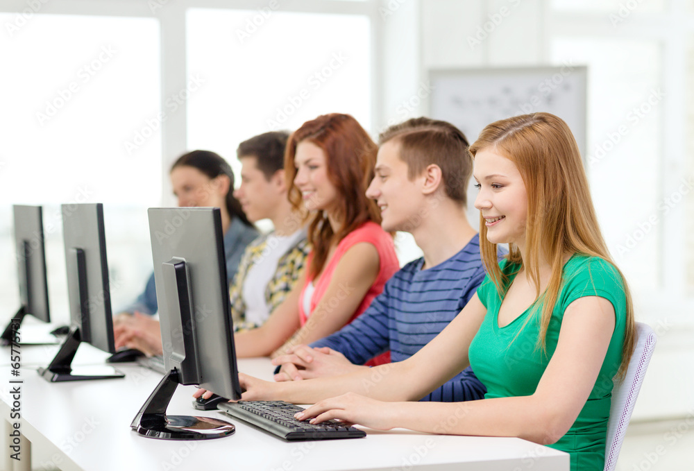 female student with classmates in computer class female student with classmates in computer class