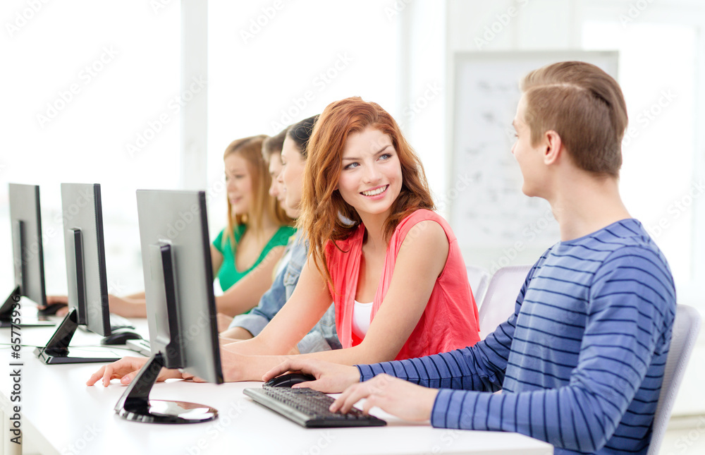 smiling students in computer class at school smiling students in computer class at school