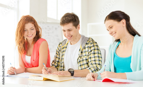 students with textbooks and books at school