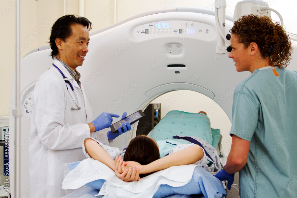 Doctor and technician with patient for CAT scan Doctor and technician with patient for CAT scan