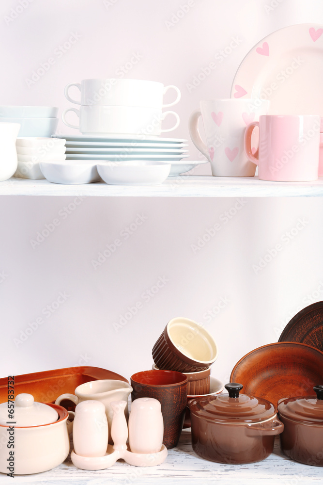 Different tableware on shelf, isolated on white Different tableware on shelf, isolated on white