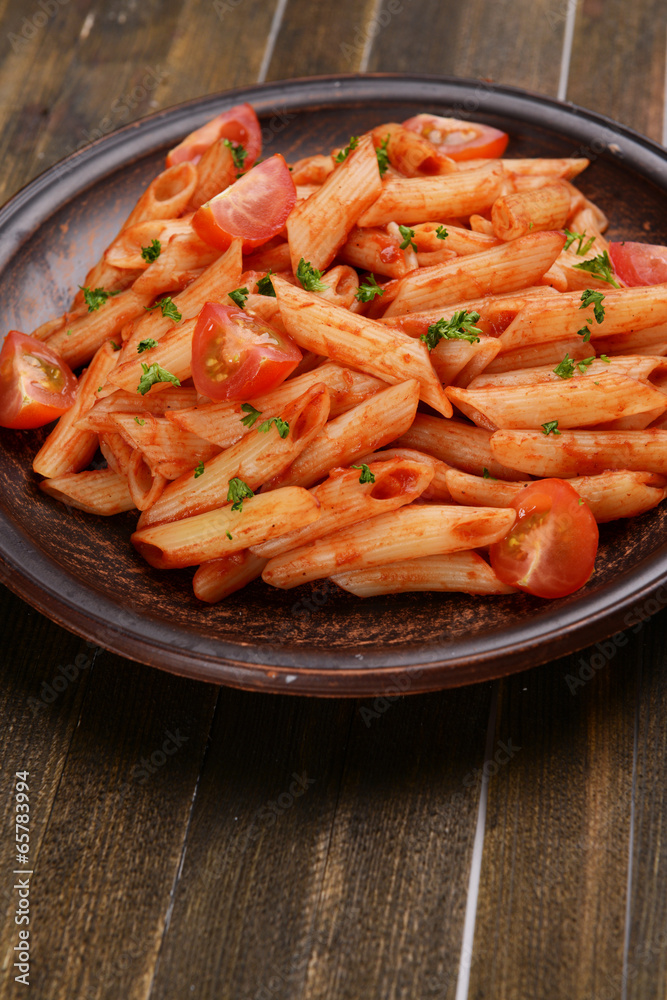 Pasta with tomato sauce on plate on table close-up Pasta with tomato sauce on plate on table close-up
