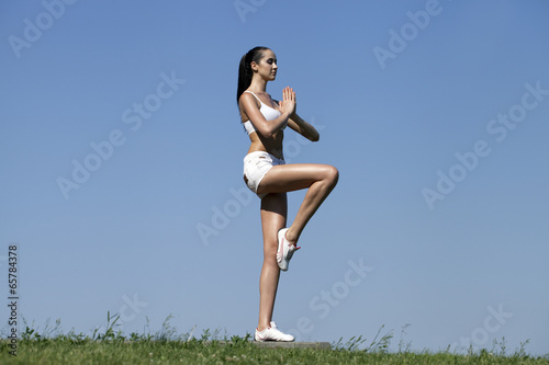 Fitness woman exercising in summer park © Andrey_Arkusha