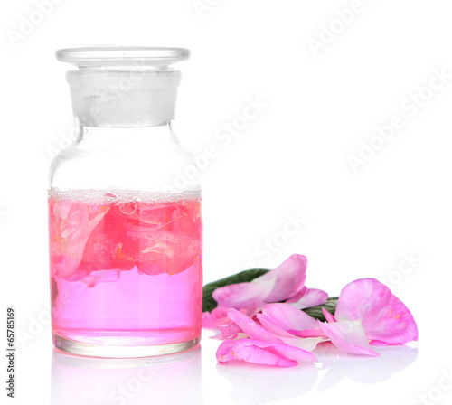 Rose oil in bottle isolated on white