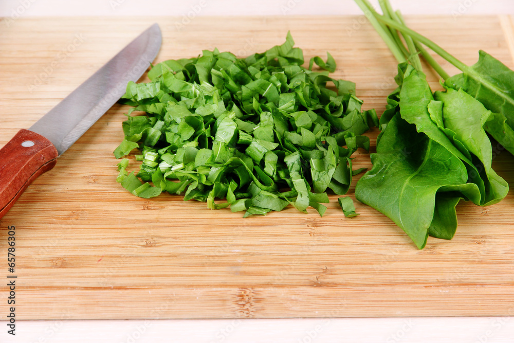 Chopped greens with knife on cutting board Chopped greens with knife on cutting board