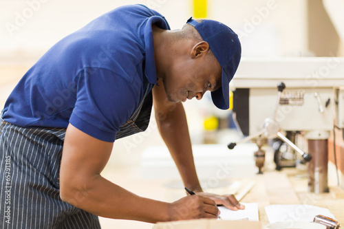 african carpenter working in workshop
