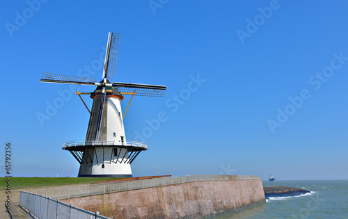 Traditional holland windmill in Vlissingen, Netherlands photo