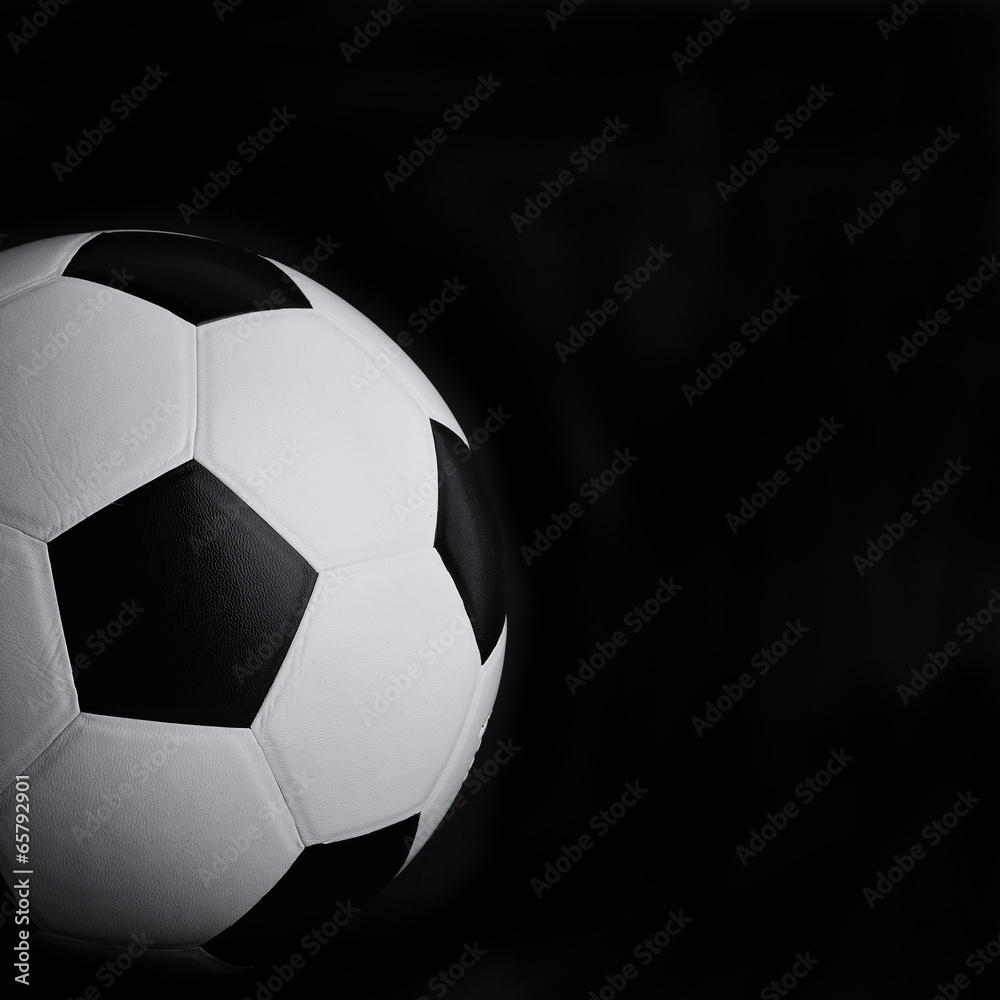 Naklejka premium soccer ball on black background