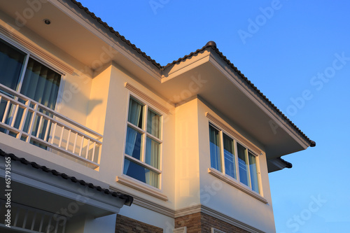 Big house modern style with sunshine and blue sky background