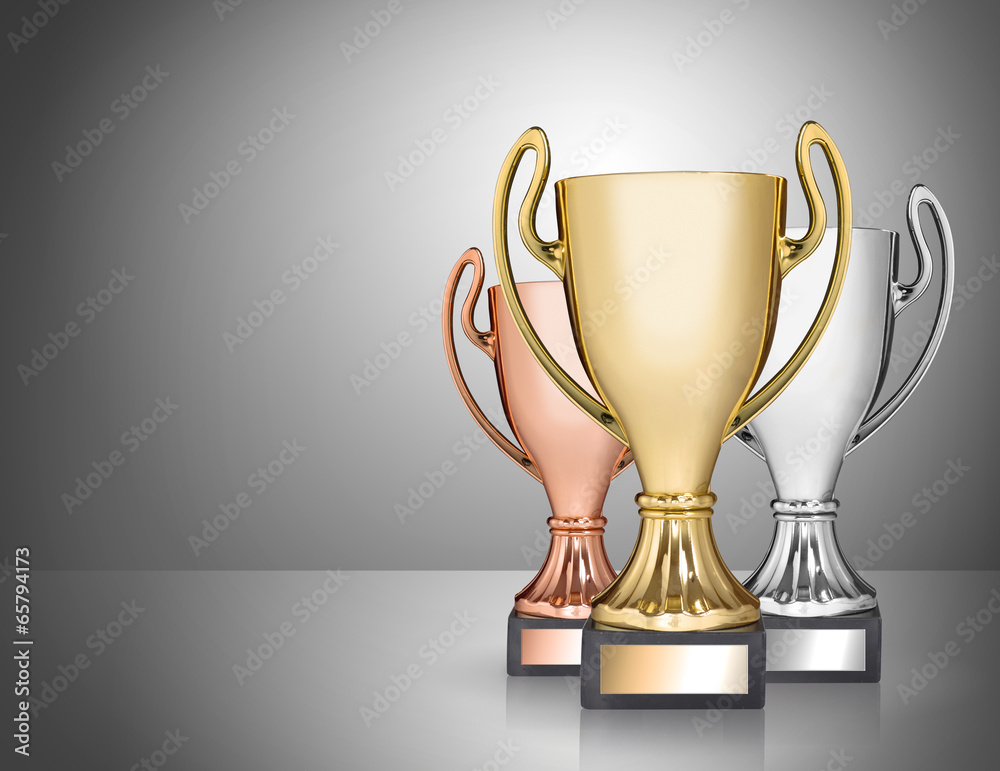 champion trophies on grey background champion trophies on grey background