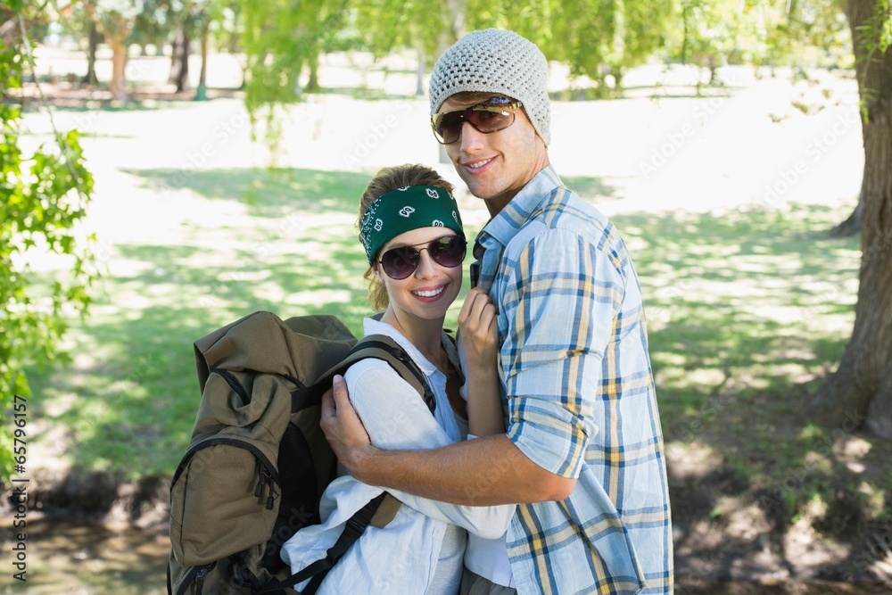 Active cute couple embracing each other on a hike smiling at cam Active cute couple embracing each other on a hike smiling at cam