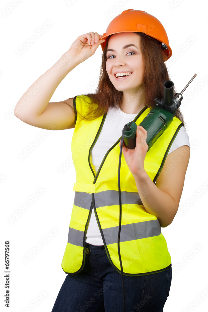 girl in a construction vest and a helmet with an electric drill. girl in a construction vest and a helmet with an electric drill.