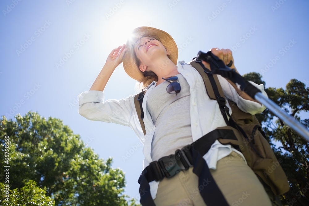 Fit woman standing with hiking pole in park Fit woman standing with hiking pole in park