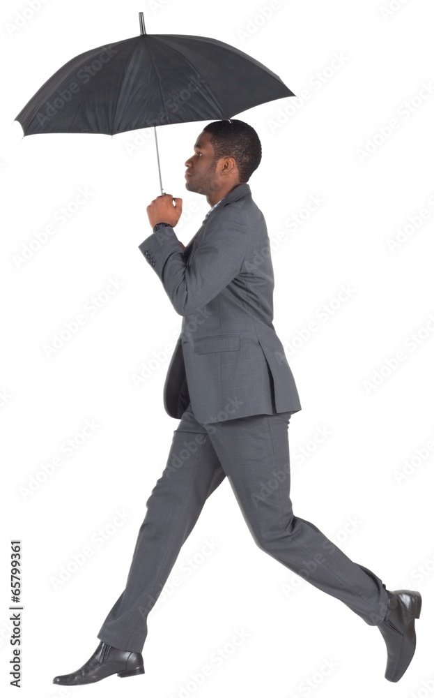 Businessman walking and holding umbrella Businessman walking and holding umbrella