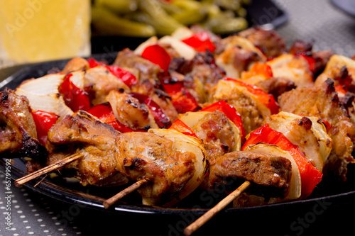 Grilled shashlik on the black plate,