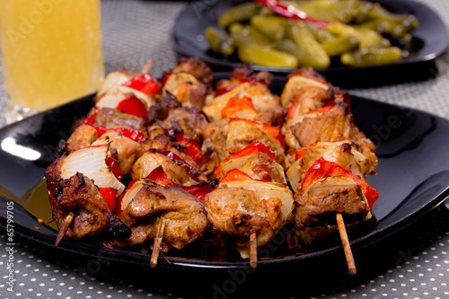 Grilled shashlik on the black plate,