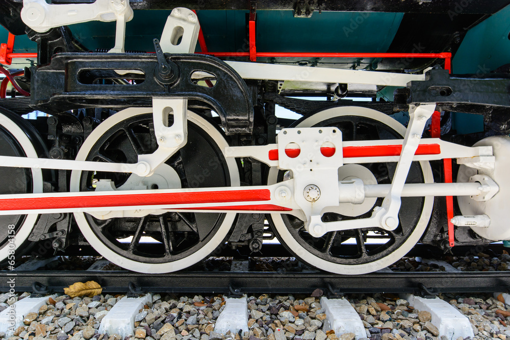 Wheels and connecting rod of old steam locomotive on railway Wheels and connecting rod of old steam locomotive on railway