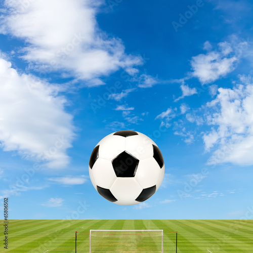 soccer ball with soccer field against  blue sky background © Satit _Srihin