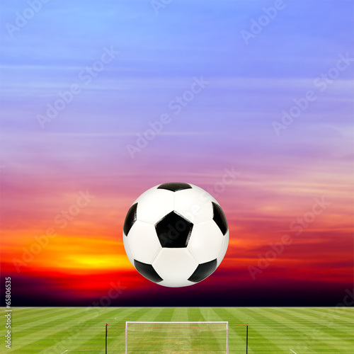 soccer ball with soccer field against beautiful sunset