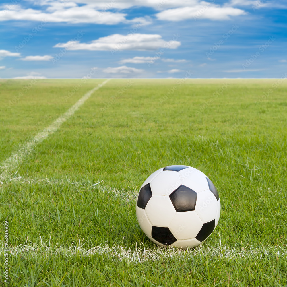soccer ball on soccer field against blue sky