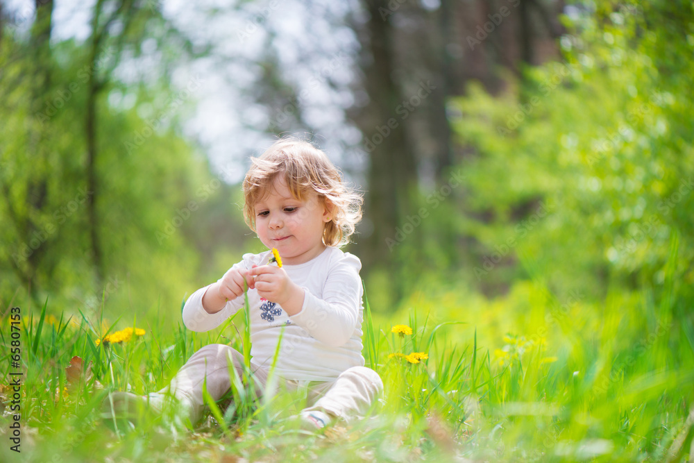 Little blonde girl in green grass Little blonde girl in green grass