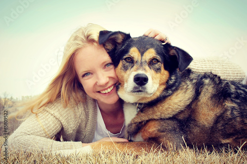 Smiling Woman Hugging German Shepherd Dog
