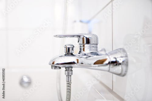 close up of luxury bathroom tap with shower in contemporary home