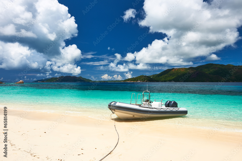 Tropical beach at Seychelles with inflatable boat Tropical beach at Seychelles with inflatable boat