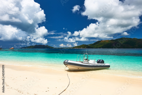 Tropical beach at Seychelles with inflatable boat