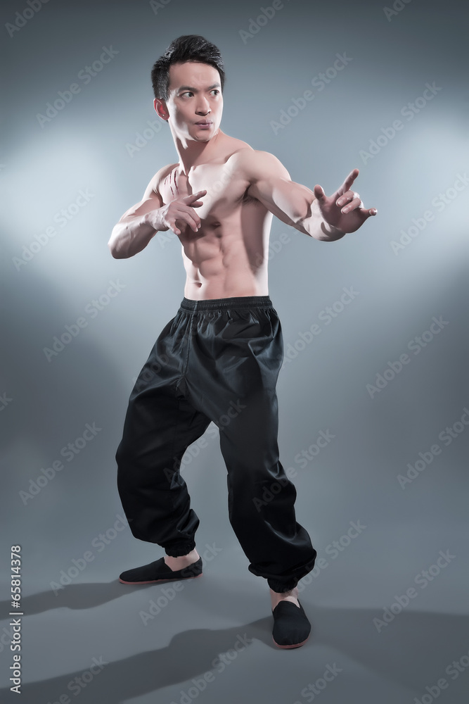 Young man doing kung fu moves in mid air Stock Photo - Alamy