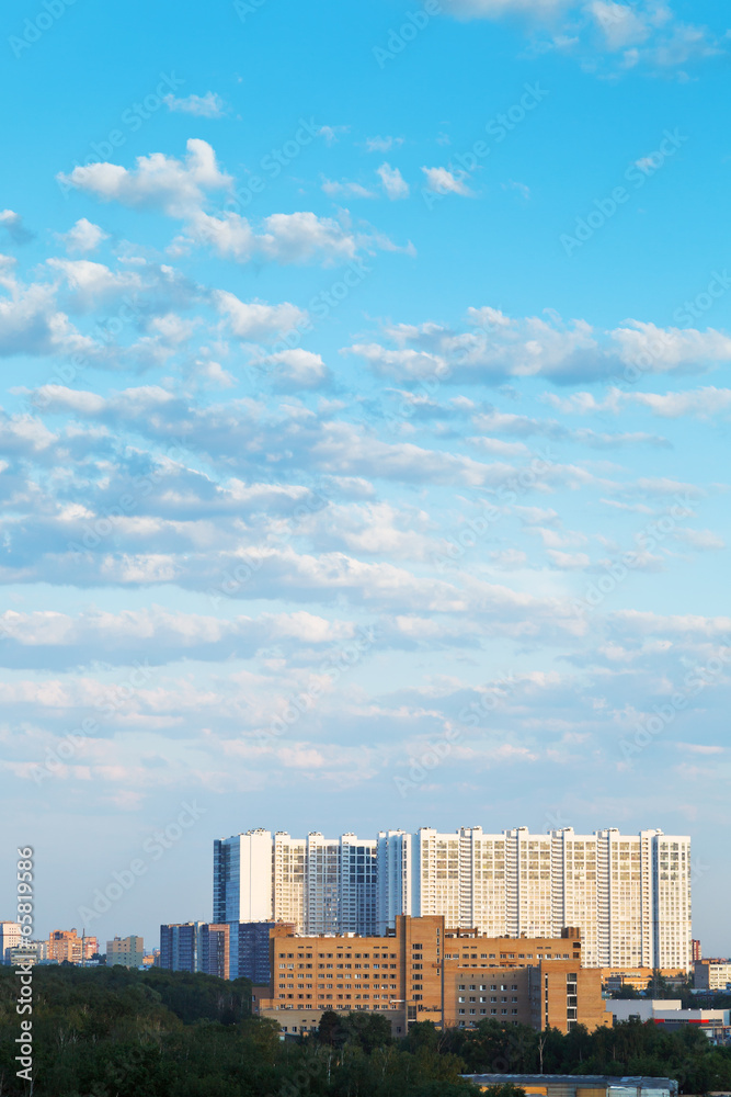 large apartment building under blue summer sky
