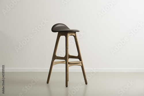 Wooden bar stool with a molded leather seat photo