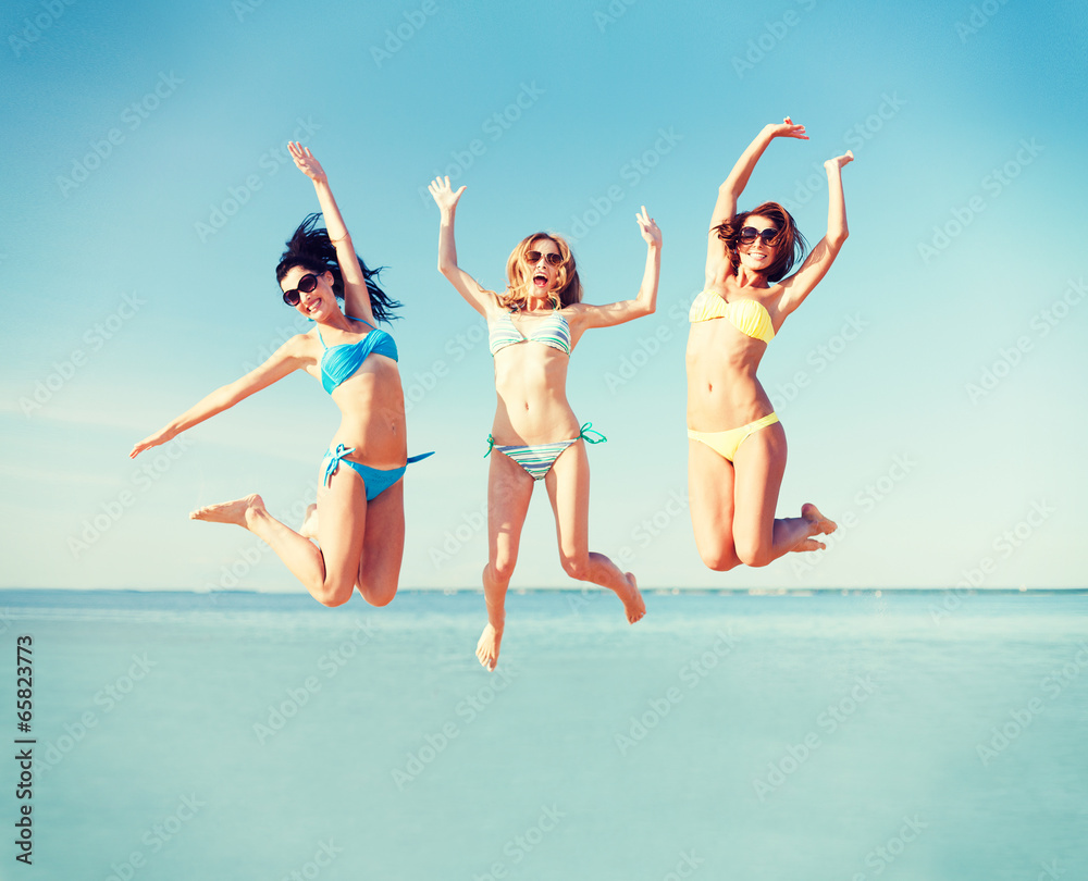 girls jumping on the beach girls jumping on the beach