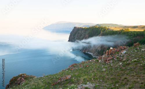 Lake Baikal. June evening with light mist on the shore