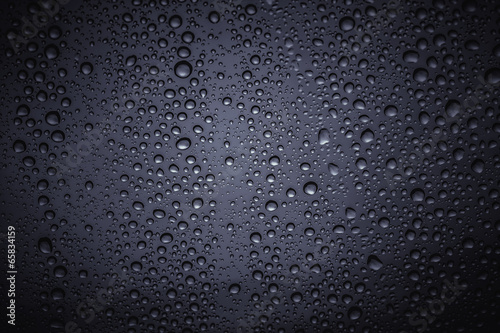 Water droplets on the glass with a colored background