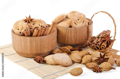 sweet sugar cookies in wooden containers with cinnamon sticks, a
