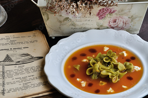 carrot soup with green pasta and pumpkin oil photo