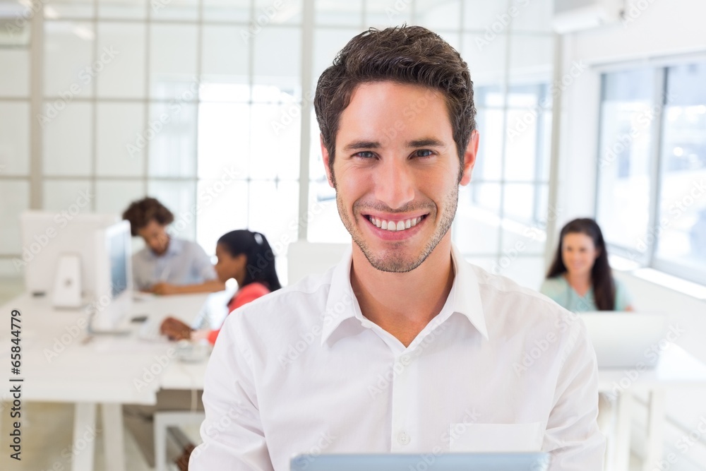 Businessman with tablet pc smiles to camera Businessman with tablet pc smiles to camera