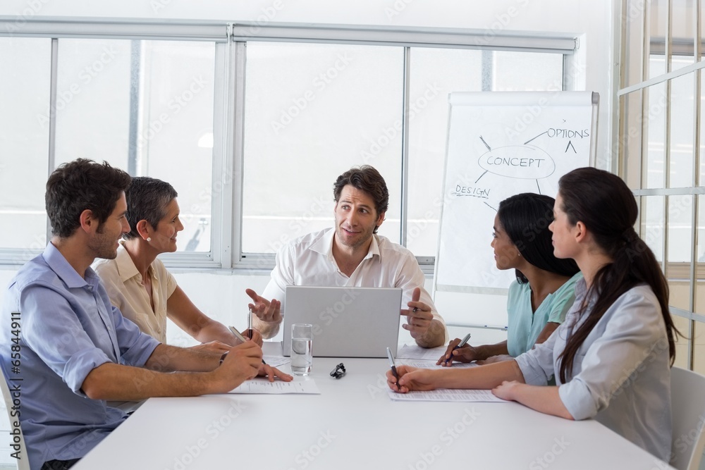 Attractive businessman speaking to coworkers Attractive businessman speaking to coworkers