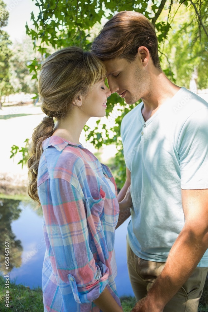 Close young couple standing together in the park Close young couple standing together in the park