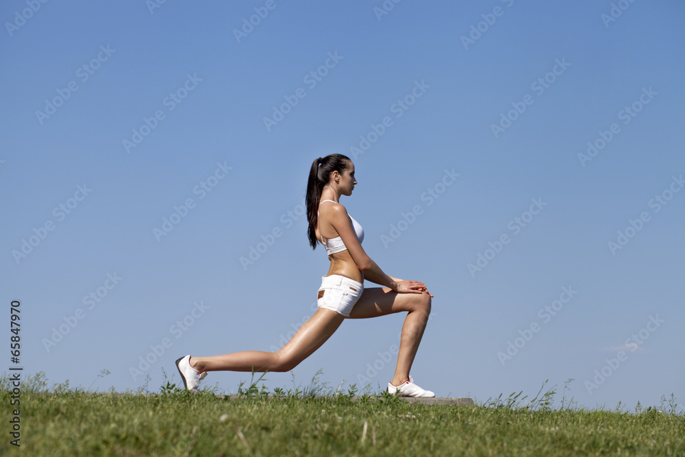 Fitness woman exercising in summer park Fitness woman exercising in summer park
