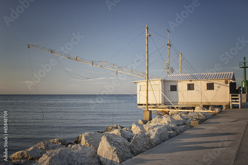 Fishing hut on the harbour channel photo